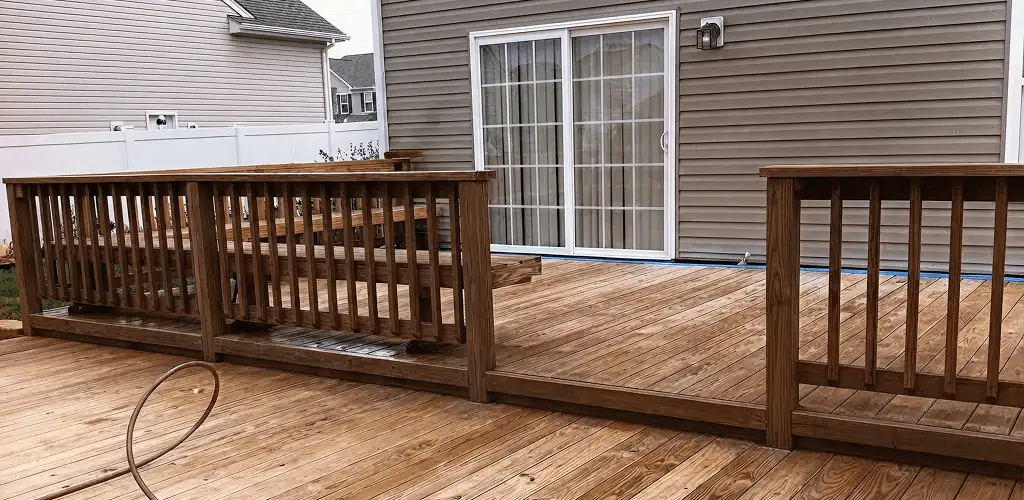 Deck sealing service protecting a backyard wood deck and railings in Eugene, OR