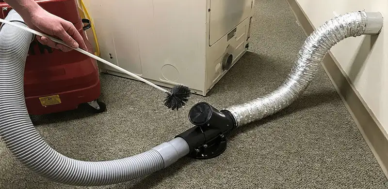 Dryer vent cleaning service removing lint from a dryer duct connection in Eugene, OR