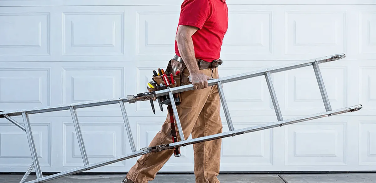Garage door repair technician arriving with tools and ladder in Eugene, OR