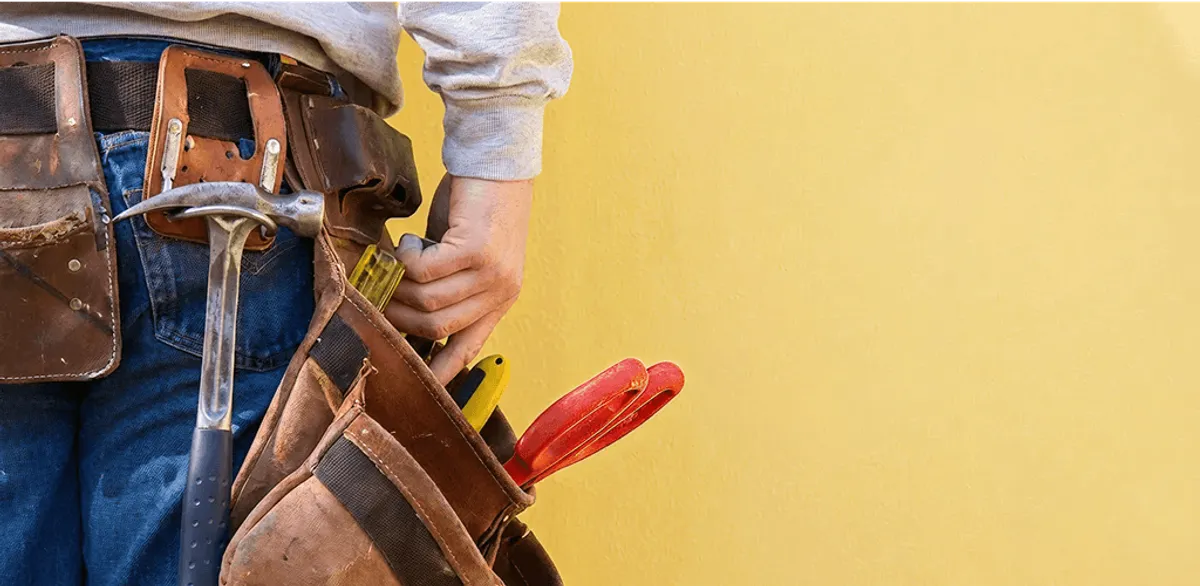 Handyman with tool belt ready for home repairs and maintenance in Eugene, OR