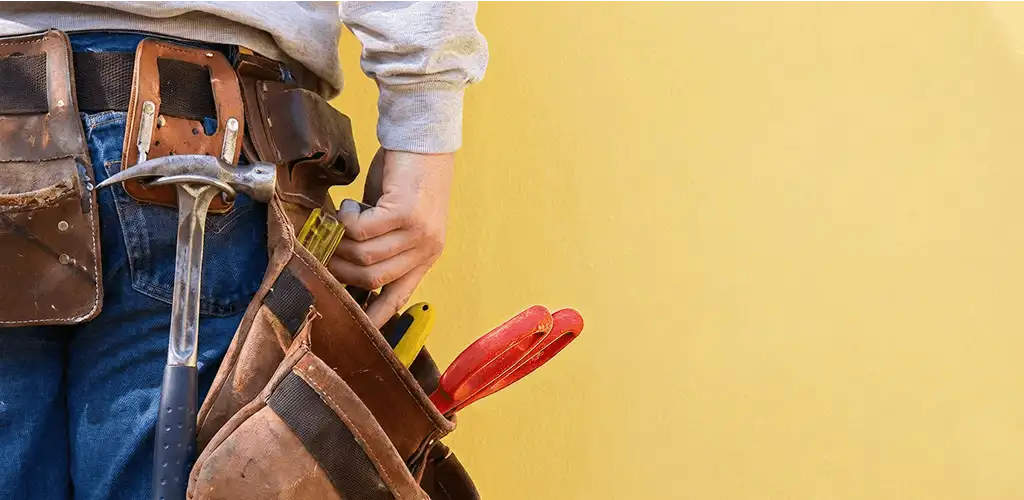 Handyman with tool belt ready for home repairs and maintenance in Eugene, OR