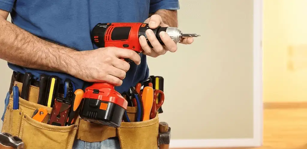 Handyman holding a power drill for home repairs and installations in Eugene, OR