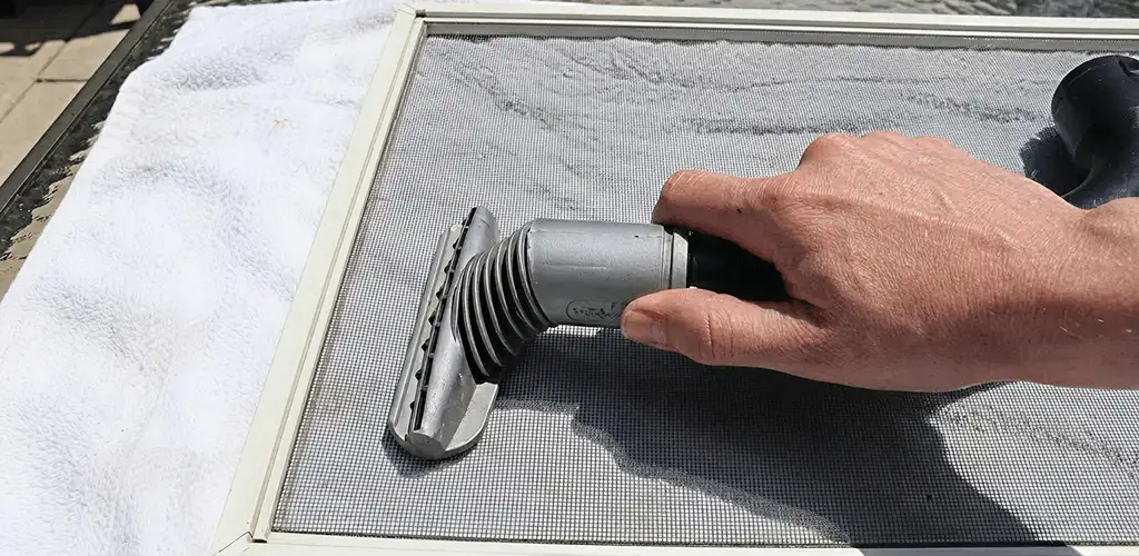 Window screen repair cleaning and fixing a damaged screen mesh in Eugene, OR